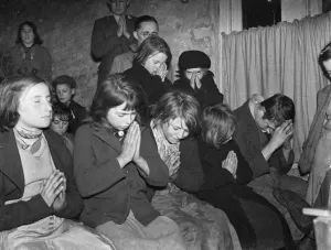 Gypsy childrens Sunday school in the cow shed in St Mary Cray. Children praying
