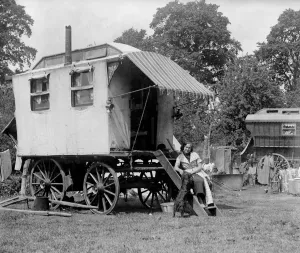 1940s Prints: A gypsy woman sitting on the steps to her Romany caravan in the gypsy camp on Epsom Downs