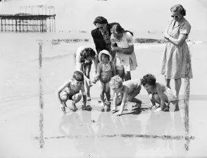 Holidaymakers Prints: Happy young holidaymakers at St Leonards on Sea show keen interest but keep their