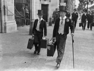 Two heavily laden Eton boys at Lords for the Eton - Harrow cricket match. Harrow