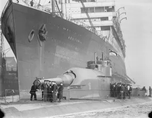 HMS Submarine No 3 The new submersible battleship, lying alongside the giant Cunarder
