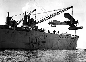 : Hoisting out a seaplane from British seaplane carrier HMS Ark Royal, Mudros