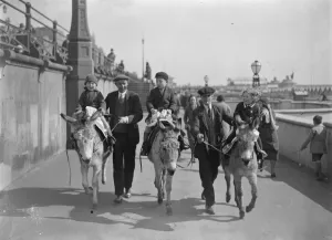 Holiday fun at Brighton. Children enjoying donkey rides in the sunshine at Brighton