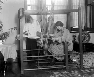 Home dyeing and weaving industry at Edgware. A pupil receives her first lesson