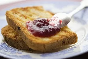 Recipe Collection: Home made jam on toast made from gluten free bread with silver spoon