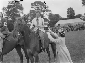 Horse jumping at the Bexleyheath Gala in Kent. The winner receives a cup after