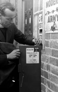 Vicar Prints: Horsmonden sub post office 149 - Modern Army poster on the wall next to letterbox