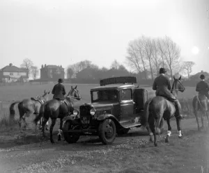 Hunting Prints: The hunt going past a Bedford lorry. 1934