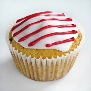 Foods Collection: Iced cupcake with red stripes on white icing credit: Marie-Louise Avery / thePictureKitchen