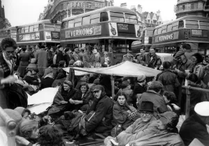 Street Prints: An improvised shelter made from a tarpaulion provides shelter from the rain for a