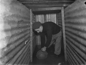 The interior of a flooded dug out in Sidcup, Kent. Mr George Harris attempts