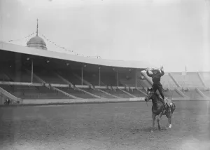 International rodeo starts at Wembley. A cowgirl gives an exhibition of trick riding