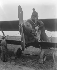 Japanese aviators return Flight to Tokyo from London. Mr Kawachi overhauling his engine