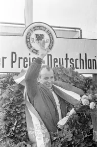 John Surtees celebrates victory for Ferrari in the German Grand Prix at Nurburgring