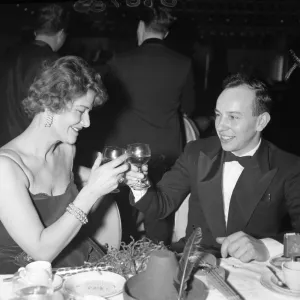 Driver Prints: John Surtees drinks a toast with a friend as the old year passes at the Talk of