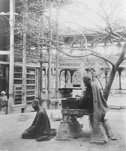 Kashmir, India Monks at their devotion in a courtyard in a Temple at Srinagar