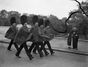Keeping their arms dry. Guards wearing their capes, a sure signthat the weather