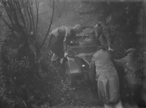 Kent Border Motor Club hill trial. Pushing a competitor up a track