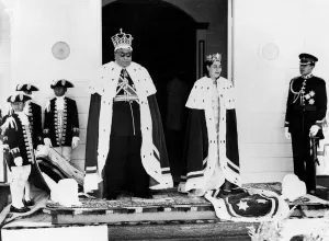 The King and Queen of Tonga, and the Crown Prince attended by their pages, pose