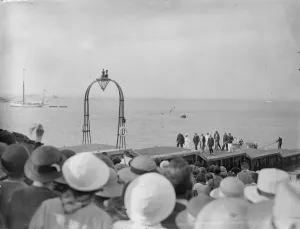 The King and Queen visit yacht squadron at Cowes. They were met by a Royal Salute