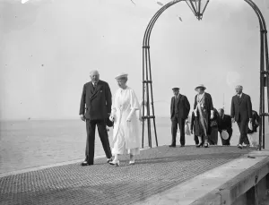The King and Queen visit yacht squadron at Cowes. They were met by a Royal Salute