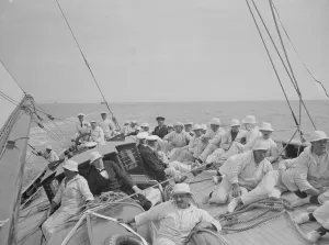 The King takes the wheel of his yacht Britannia. Making a fine run, a photo