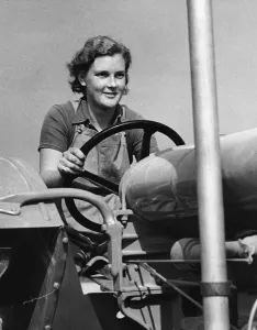Land Girl driving a tractor during WW2 - a girl now in training for the Womens