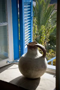 Blue Prints: A large earthenware jug on the window sill of a Cypriot house in southern (Greek)