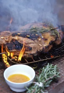 Bowl Prints: Leg of lamb, butterflied to flatten being barbecued on charcoal grill with rosemary