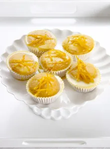 Cooking Prints: Six lemon drizzle fairy cakes on white cake stand credit: Marie-Louise Avery / thePictureKitchen