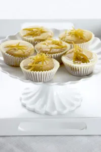 Cooking Prints: Lemon muffins with lemon zest glaze on white cakestand credit: Marie-Louise Avery