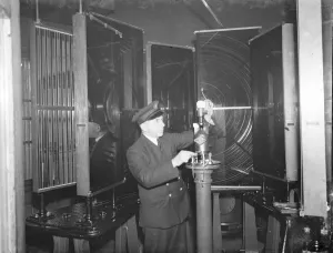 Lantern Prints: A lighthouse keeper checks the Dungeness lighthouse bulb in the lantern room