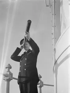 Keeper Prints: Lighthouse keeper uses a hand telescope to take bearings of lightships from the gallery