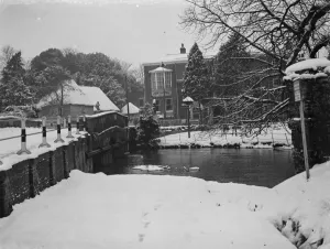 Hotel Prints: The Lion pub in Farningham, Kent, viewed from over the river Darent