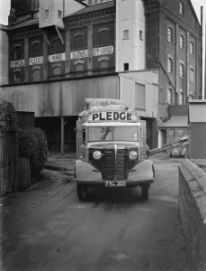 A loaded Bedford truck belonging to Pledge & Son Ltd, the milling company, pulls