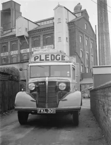 A loaded Bedford truck belonging to Pledge & Son Ltd, the milling company, pulls