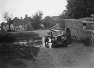 Bridge Prints: Locals wash their vehicle in the river in Eynsford. 1935