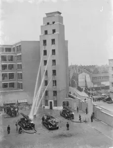 A London Fire Brigade display in Lambeth, London. Firemen hose down from the windows