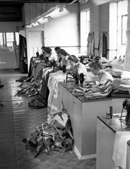 Decorations Collection: London Girl workers at an Old Kent Road Flag and Decorations making factory sew pieces
