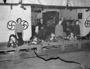 London office girls become expert with the rifle. Girls employed in the offices