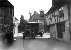 Lorry driving past Ye Old George In garage in Shoreham. 1934