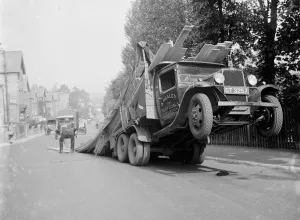 A lorry tips backwards, spilling its load in Sevenoaks, Kent. 1935