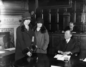 The loser, Miss Rose Sear throwing the dice. The Mayor of Guildford is seen presiding