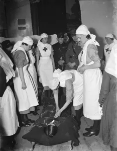 Apron Prints: Major M J Malling overlooks the Voluntary Aid Detachment demonstration in Orpington