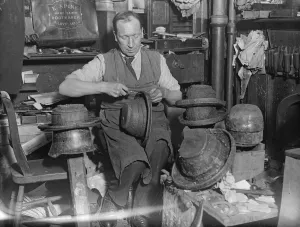 Making Londons queerest hats. In the steep winding alleyway which slopes into