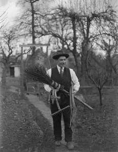 Tools Prints: Man carrying garden tools, rake, spade and besom broom. 1935