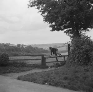 Fence Prints: A man crossing a stile in Cudham, Kent. 1936
