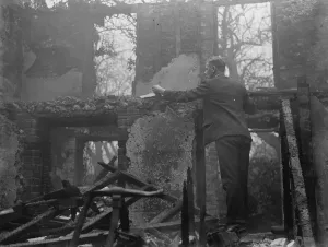 Debris Prints: A man examines what is left behind following a cottage fire in Chelsfield, Kent