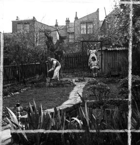 Swing Prints: Man Gardening, while children play on swing 1946 [no caption, location or date]