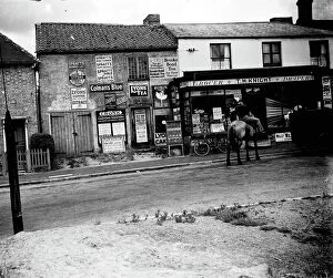 Press Collection: Man on horseback in front of grocers shop around Sevenoaks area, Kent. Advertisements and signs